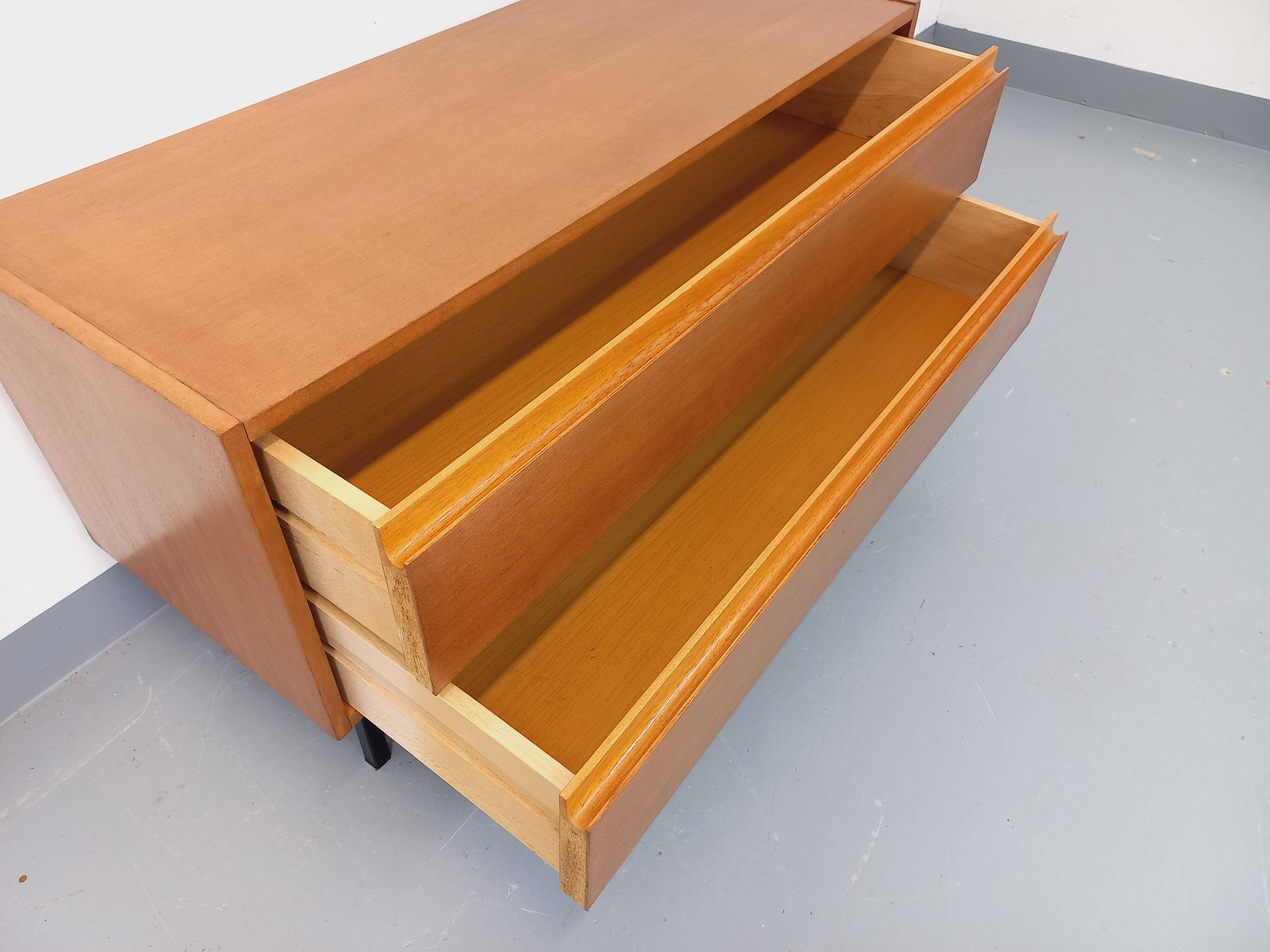 Small vintage Scandinavian sideboard in modernist style made of light oak wood.