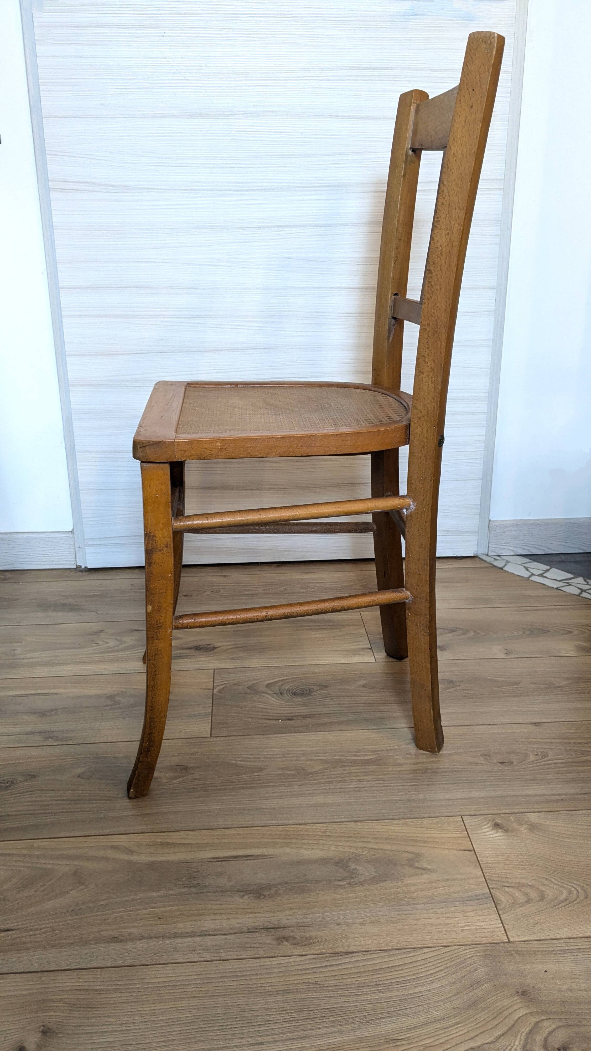 Antique patinated wooden bistro chair from the early 20th century.