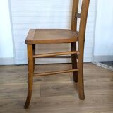 Antique patinated wooden bistro chair from the early 20th century.