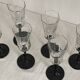 Set of 6 Octime champagne flutes in glass with black stem.