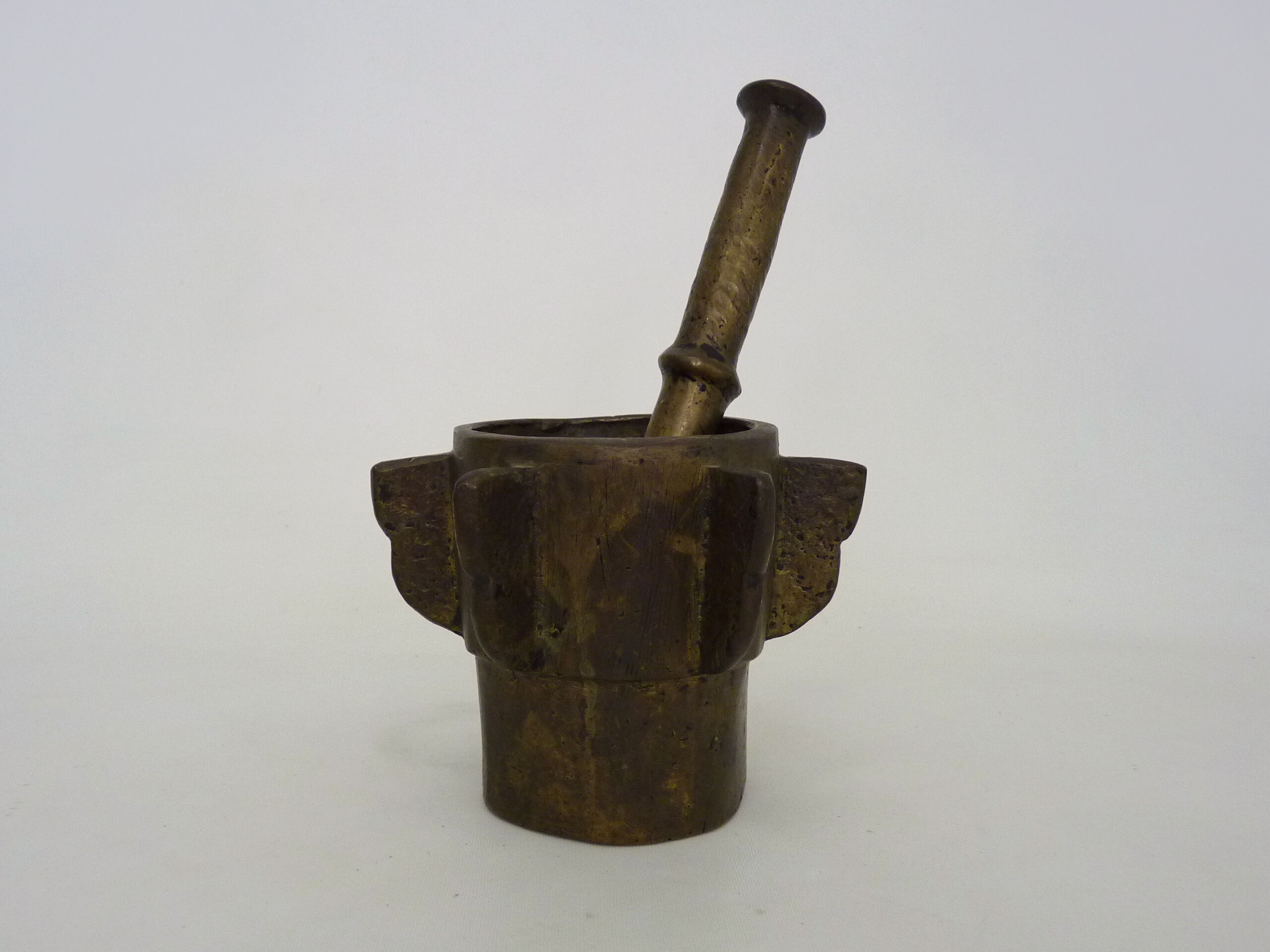 Old apothecary mortar with fins and its bronze pestle
