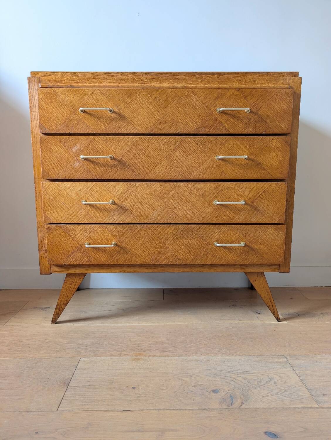 Vintage chest of drawers with checkerboard and compass feet