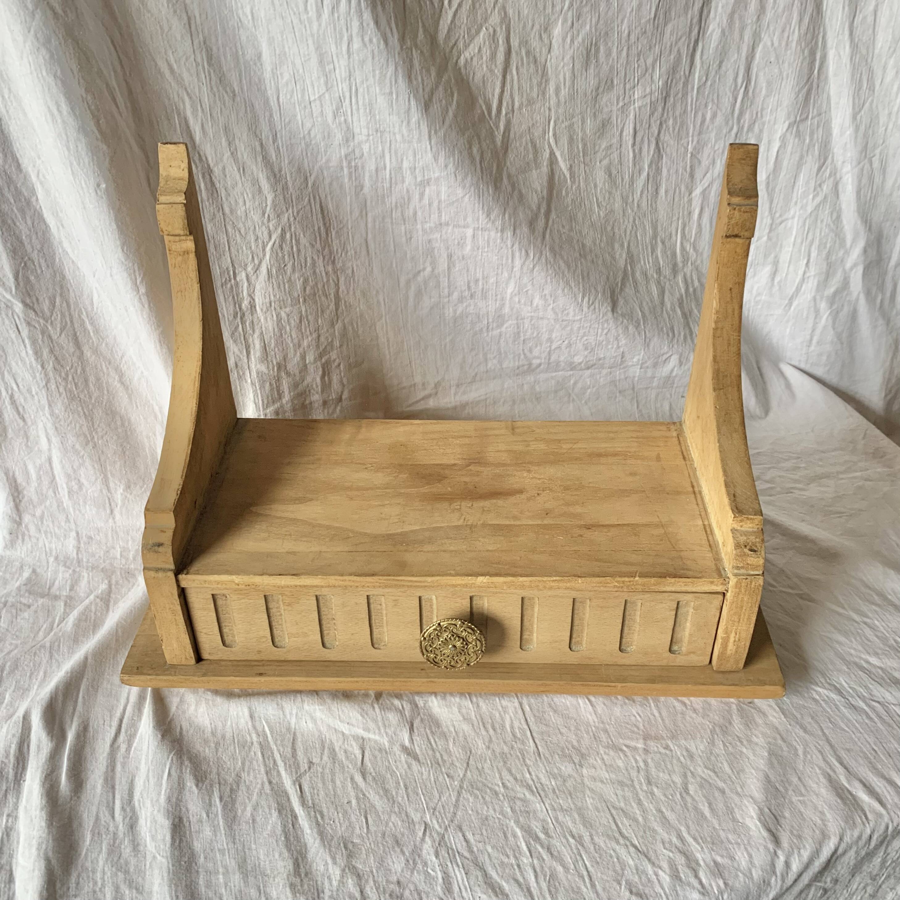 Old small hanging shelf in solid wood