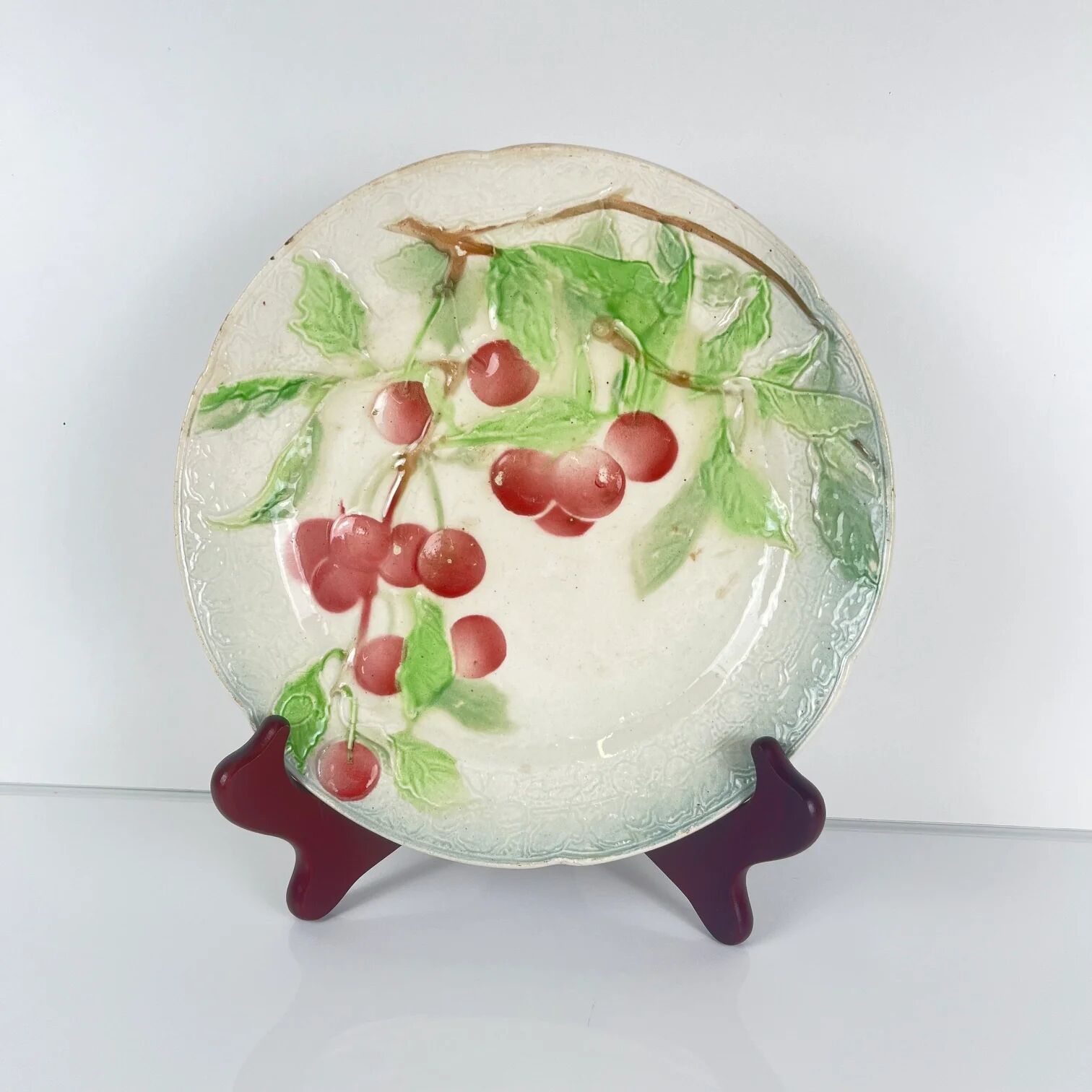 Set of 4 plates KG St Clément barbotine fruit (cherry, mirabelle, grape, pear), late 19th-early 20th century.
