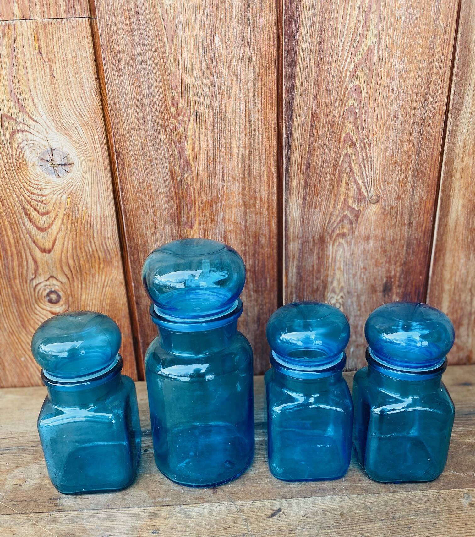 Set of 4 vintage blue glass jars.