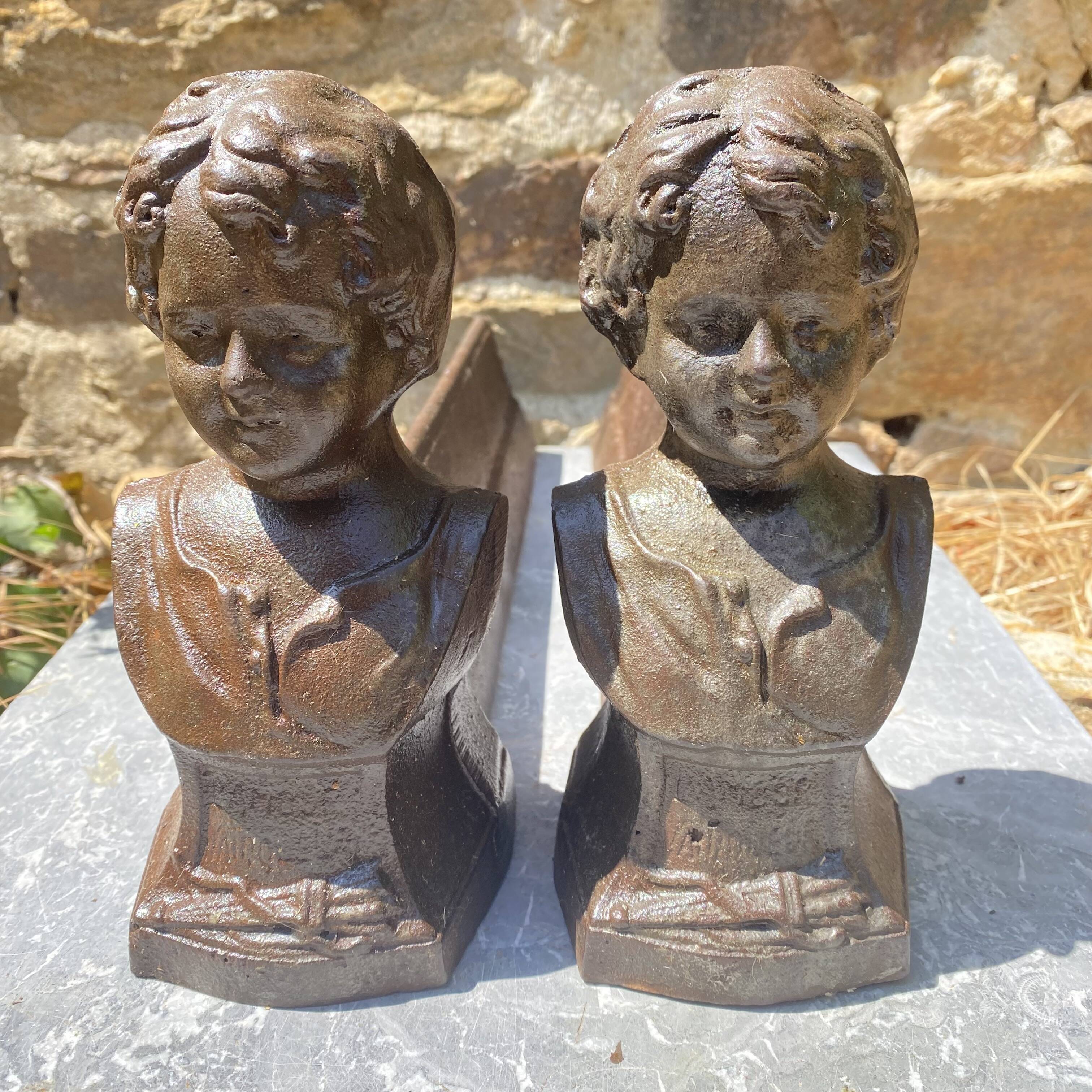Pair of antique cast iron fire dogs "The Conquering Love"