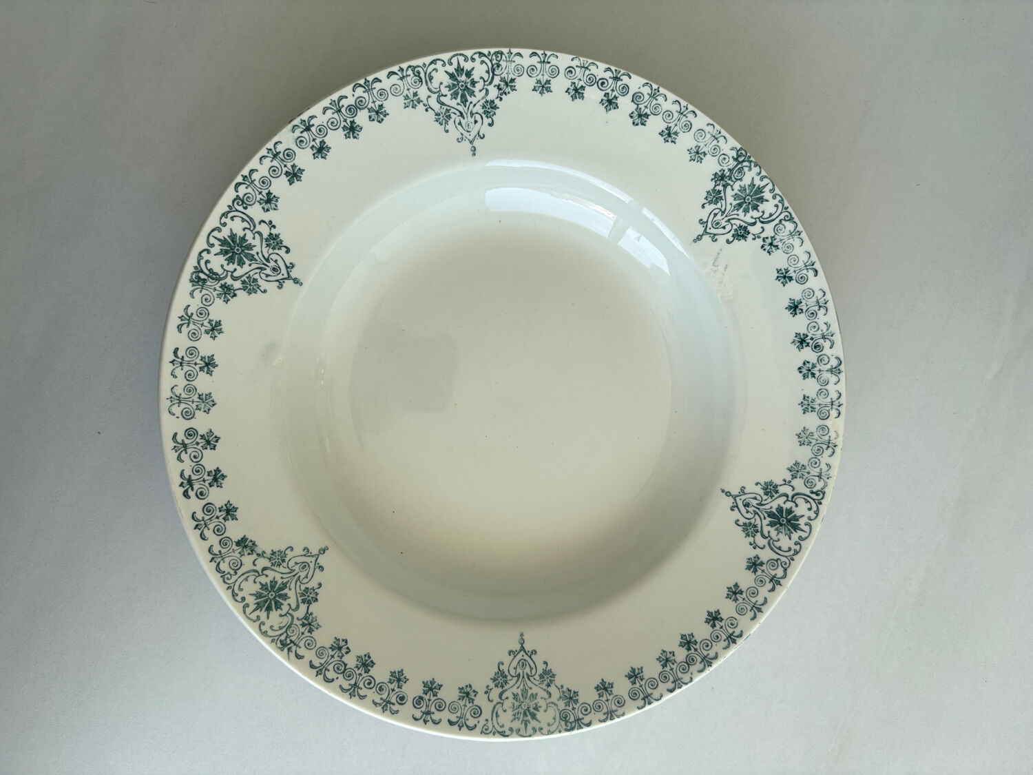 A deep plate in blue and green ironstone, antique French earthenware.