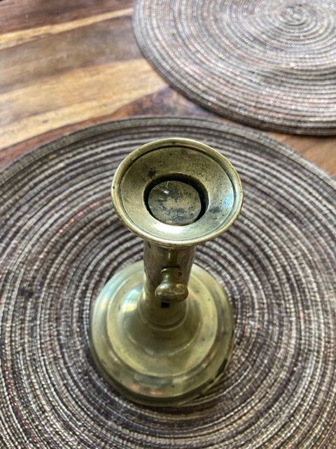19th century brass candlestick says "to binet"