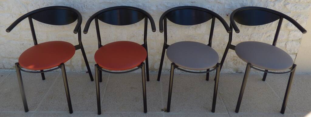 4 gondola-style chairs with a sturdy metal frame and faux leather.