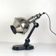 Directional articulated lamp in nickel-plated chrome and black bakelite, with cast iron counterweight.