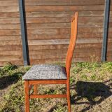 Set of 8 teak lounge chairs with high backs and zebra-striped seats