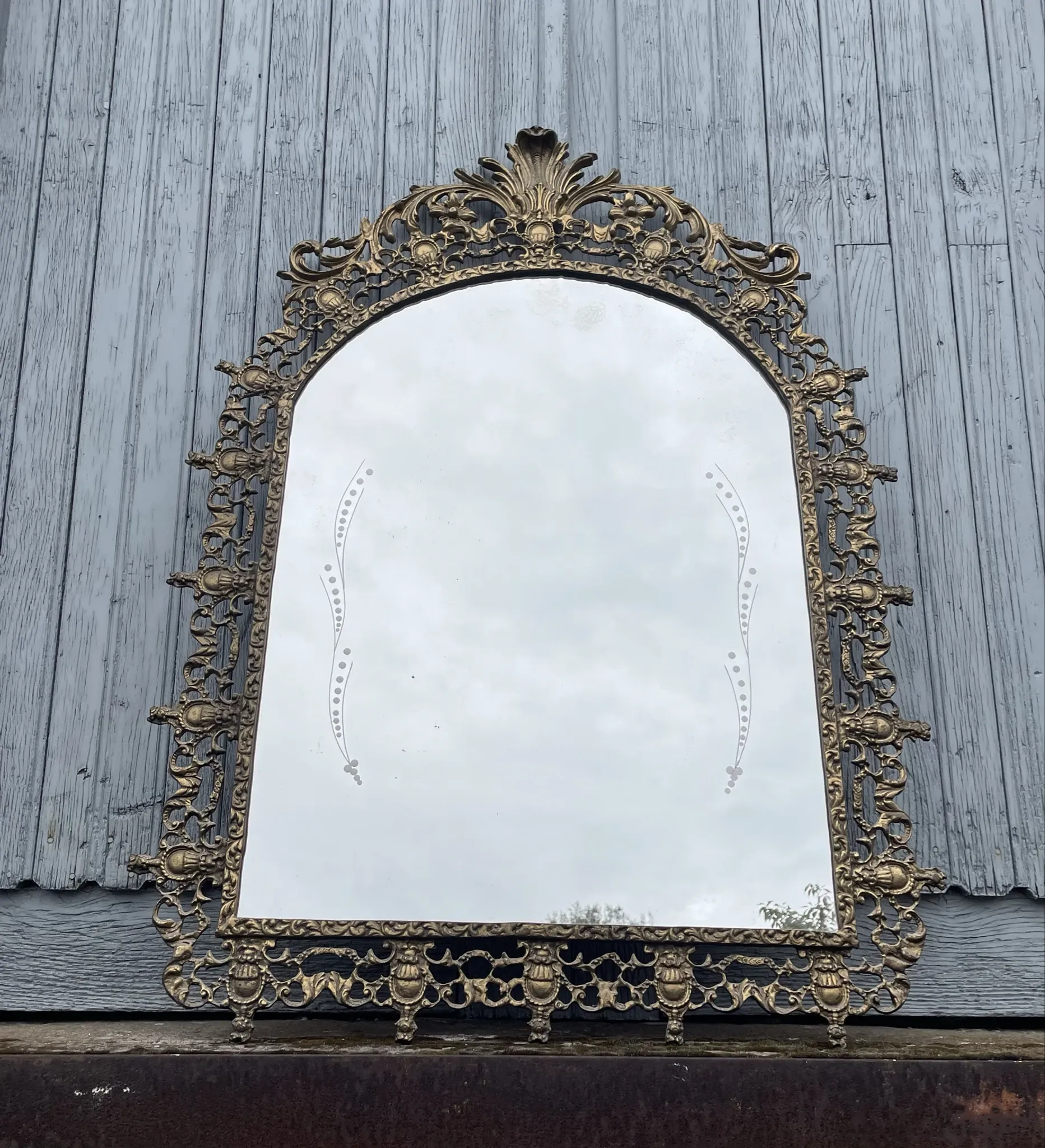 Vintage brass wall mirror adorned