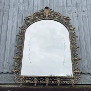 Vintage brass wall mirror adorned