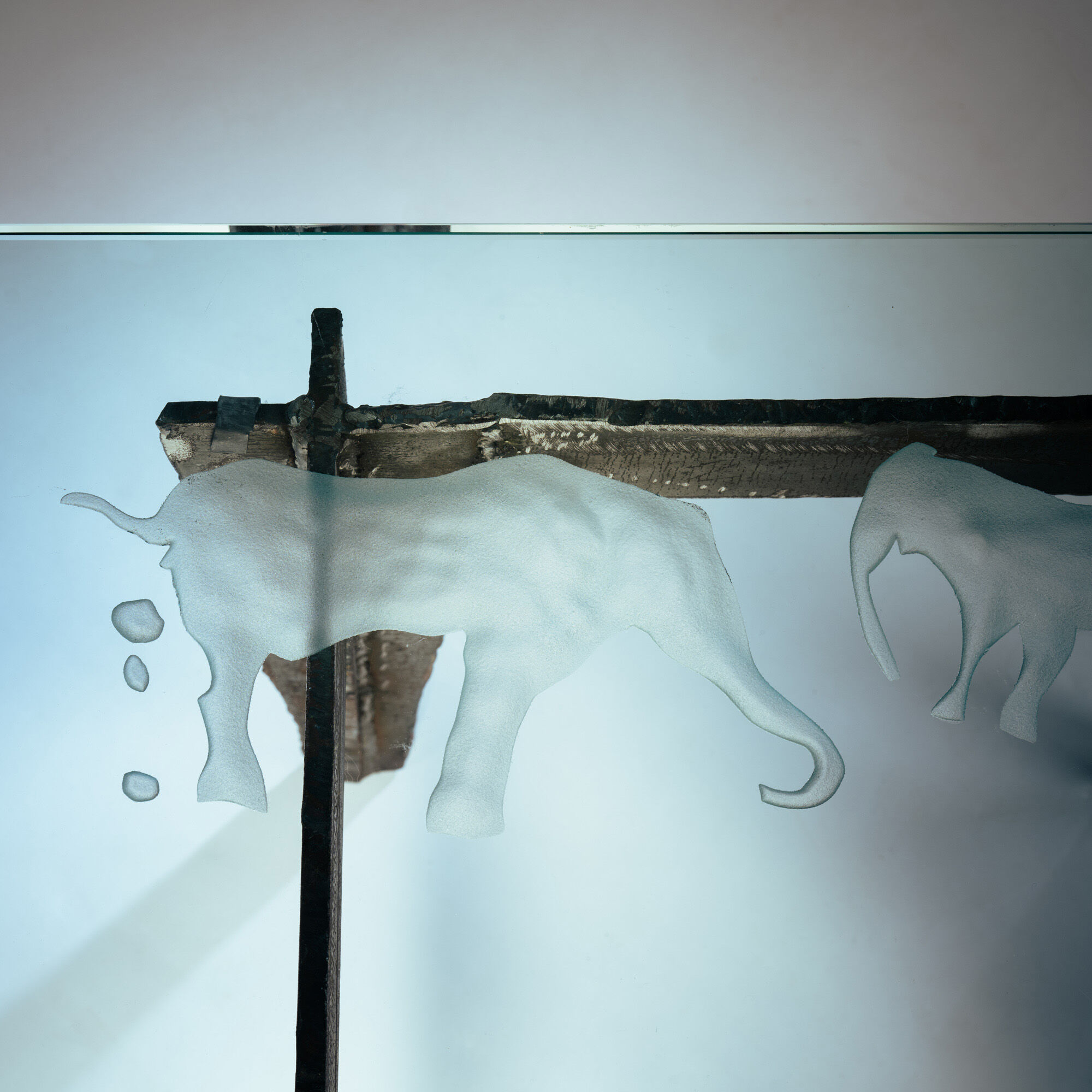 2 brutalist steel side tables with primitive  scene motifs etched glass
