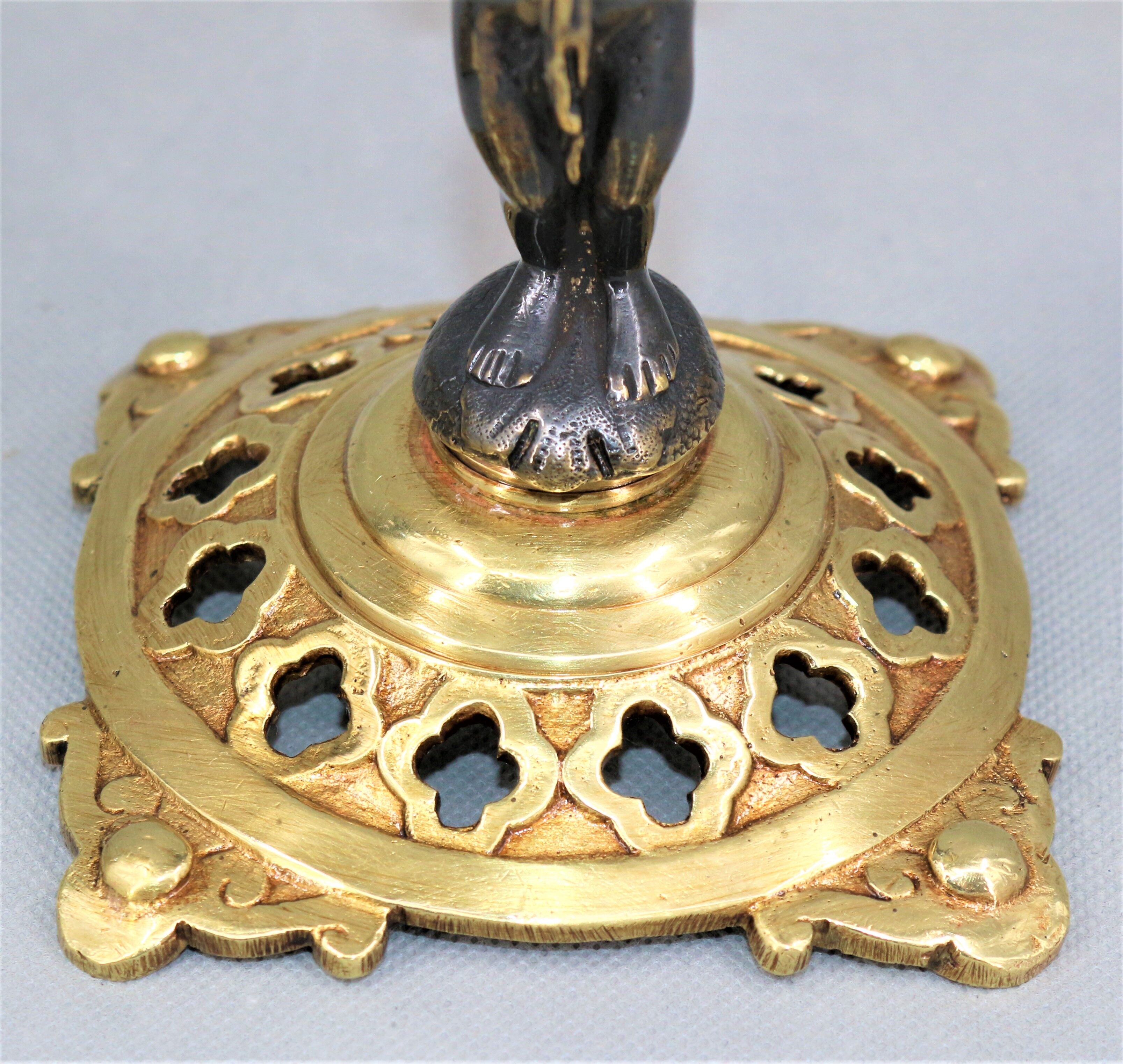 Pair of candle holders in gilded bronze and patinated with a candle