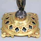 Pair of candle holders in gilded bronze and patinated with a candle
