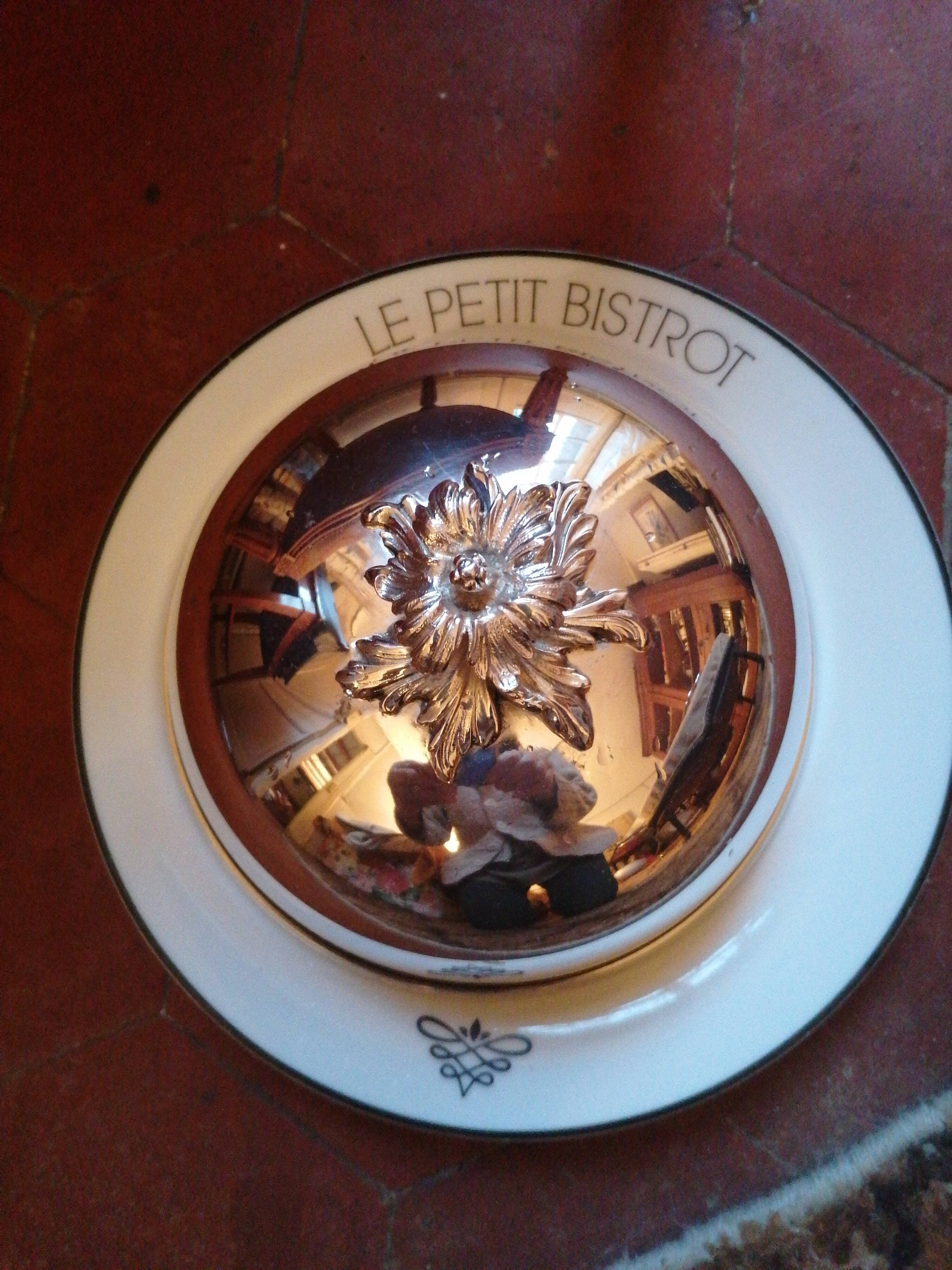 Silver metal bell on its porcelain dish