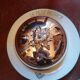 Silver metal bell on its porcelain dish