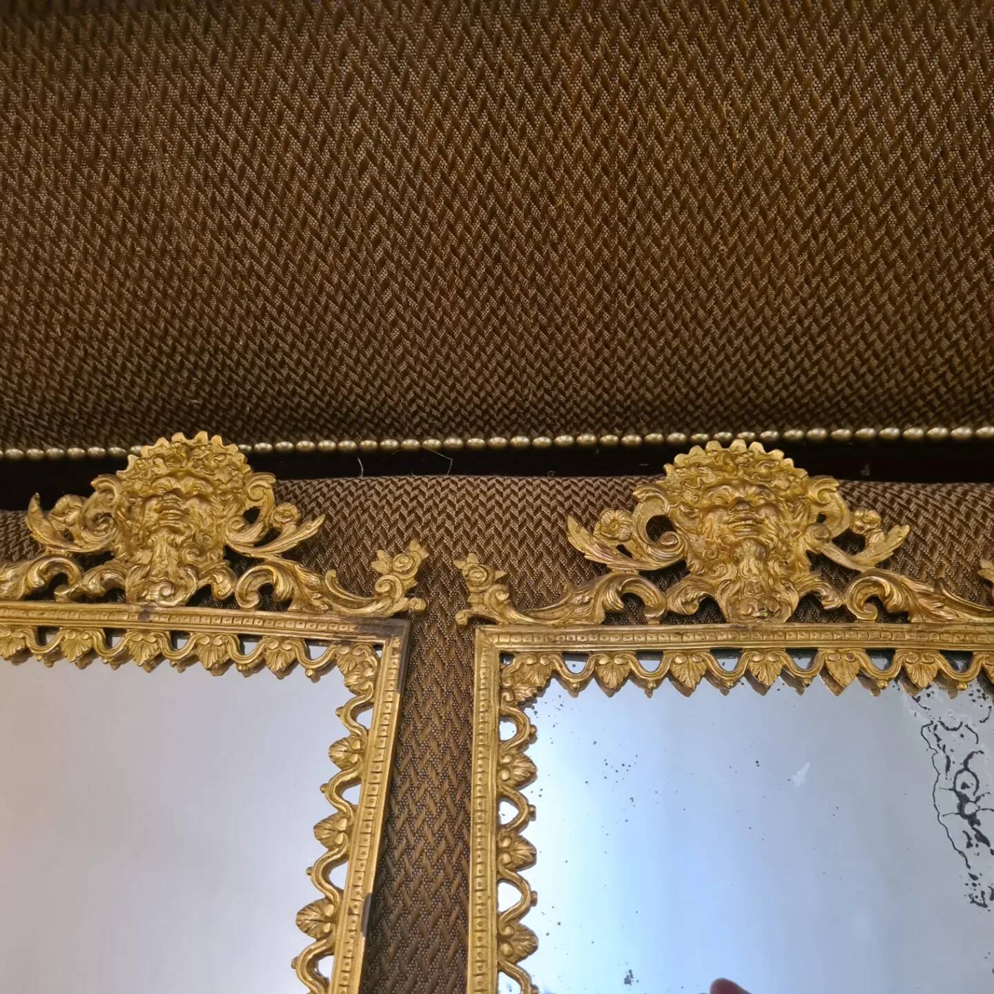 Pair of wall lights with mirror backgrounds with 3 arms of lights in chiseled and gilded bronze. framing decorated with foliage and masks. louis xiv style