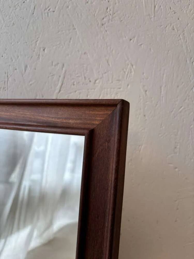 Danish wall mirror from the sixties with a sleek design.