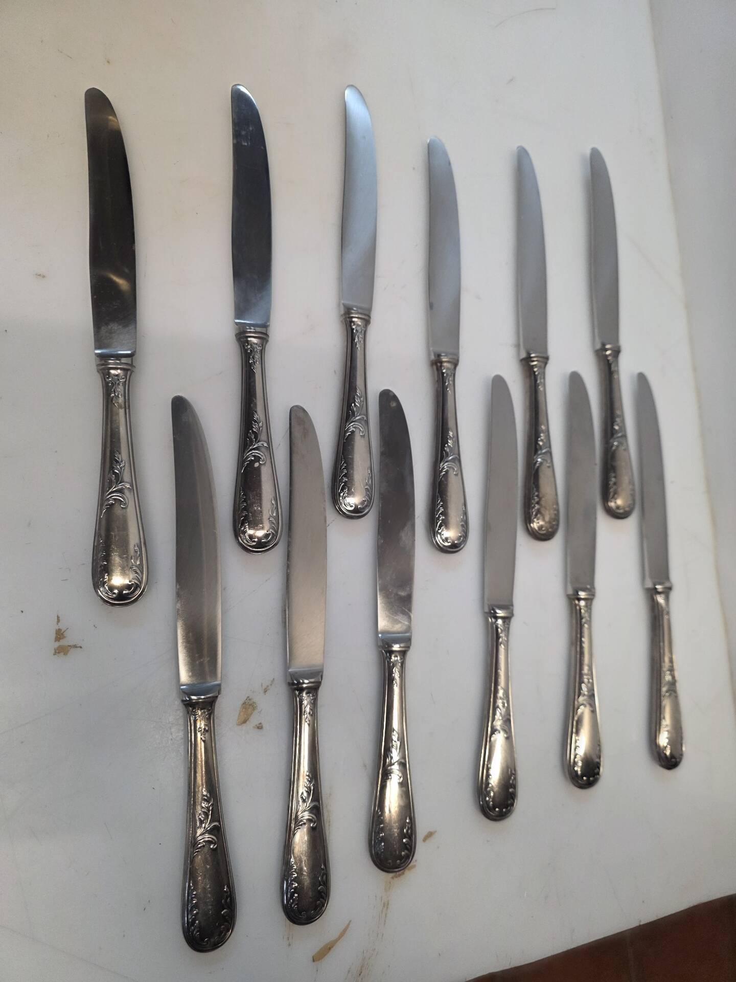 12 silver-plated metal knives from the mid-20th century
