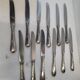 12 silver-plated metal knives from the mid-20th century