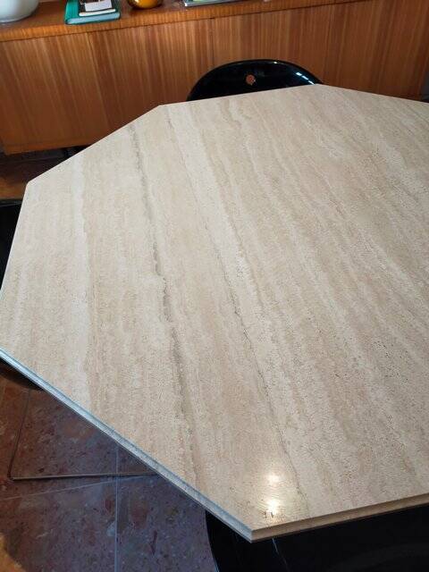 Octagonal dining table in travertine