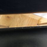 Chrome metal chairs and black faux leather upholstery in retro modernist style.