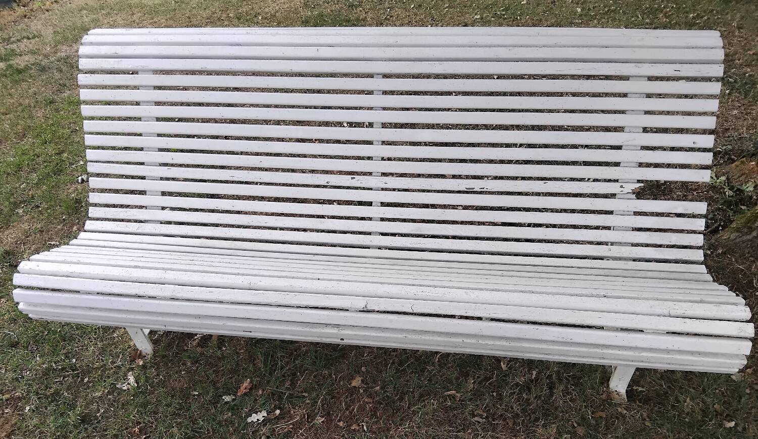 Old garden bench with metal legs and wooden slats