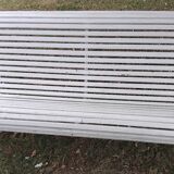 Old garden bench with metal legs and wooden slats