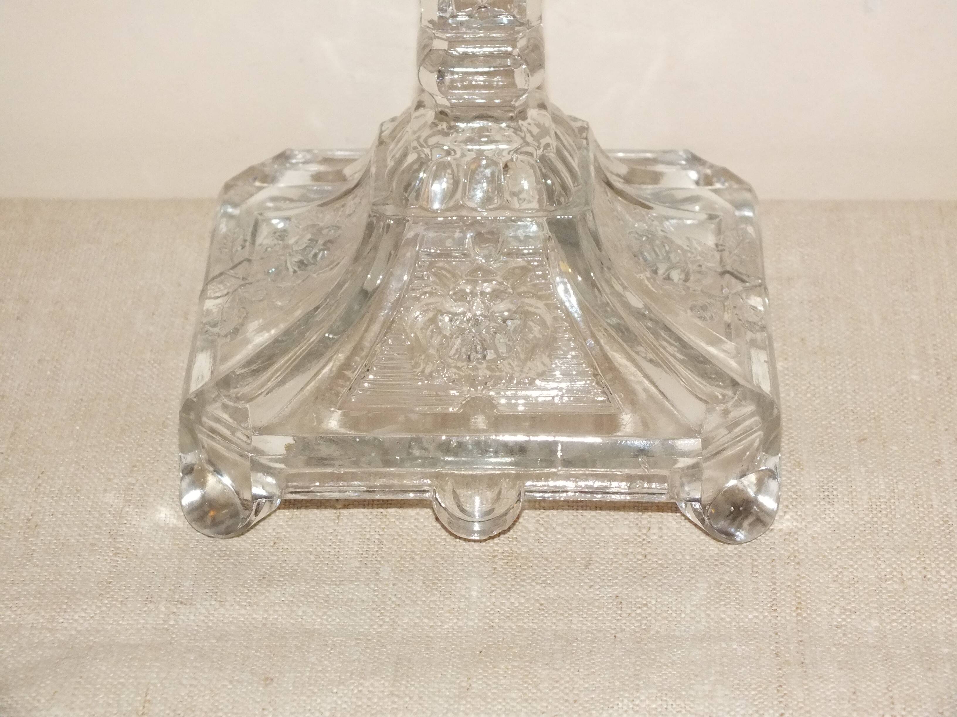 19th century candlestick in molded glass decorated with roses and lions