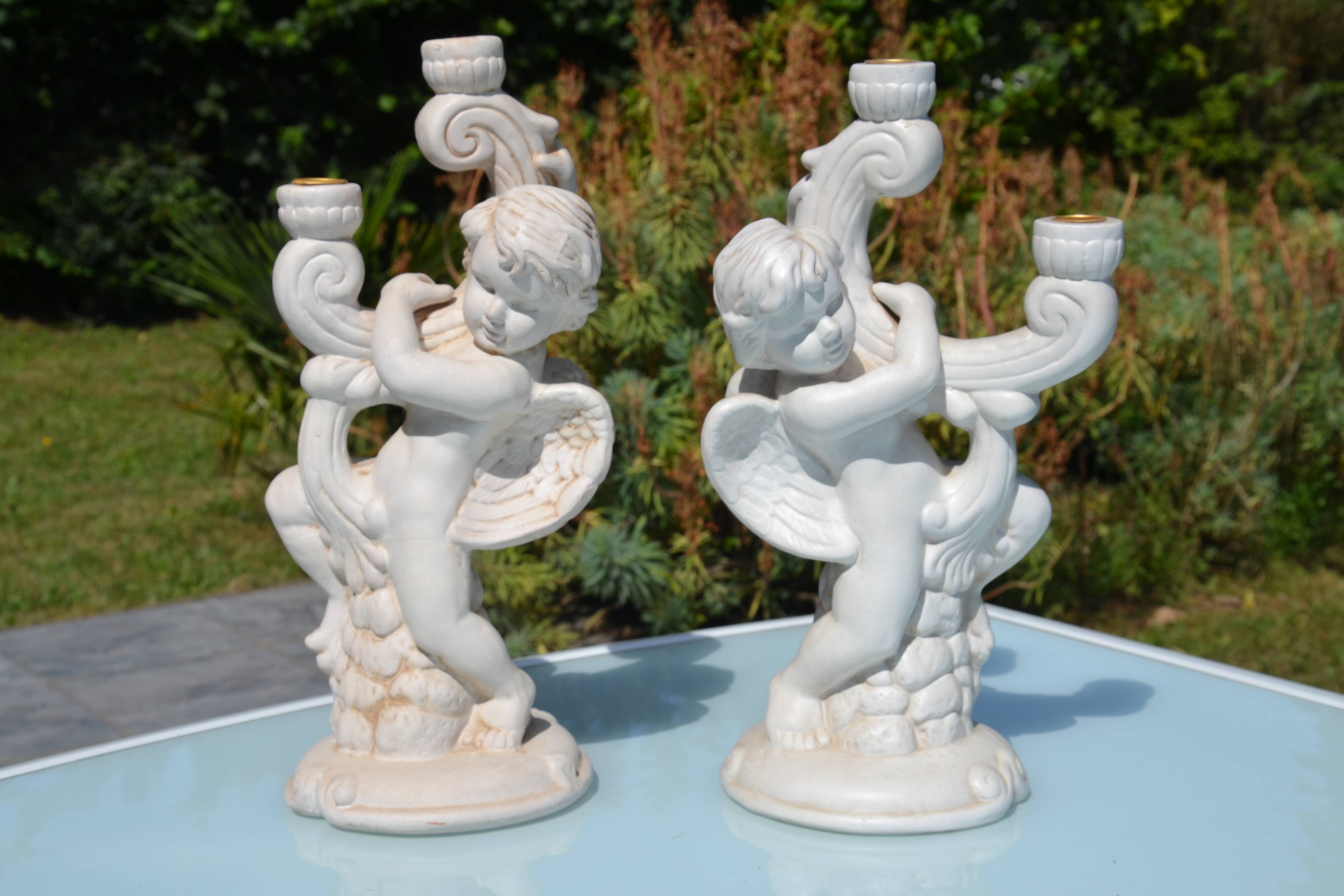 Pair of "cherub" candle holders in plaster