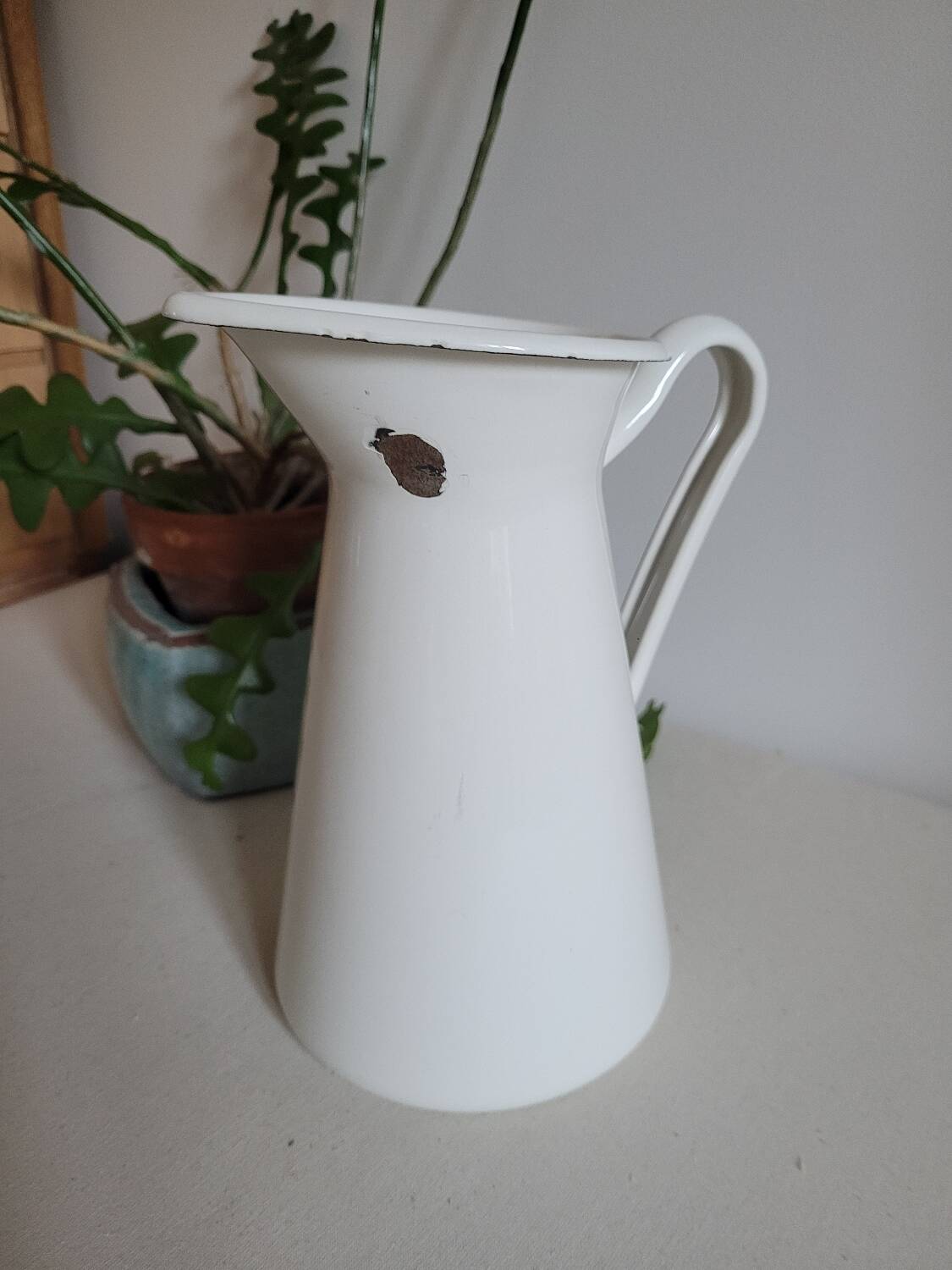 White enamelled metal jug