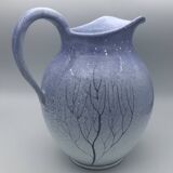 Blue glazed terracotta pitcher with hand-painted decoration, signed