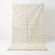 Ecru Moroccan rug with black dots.