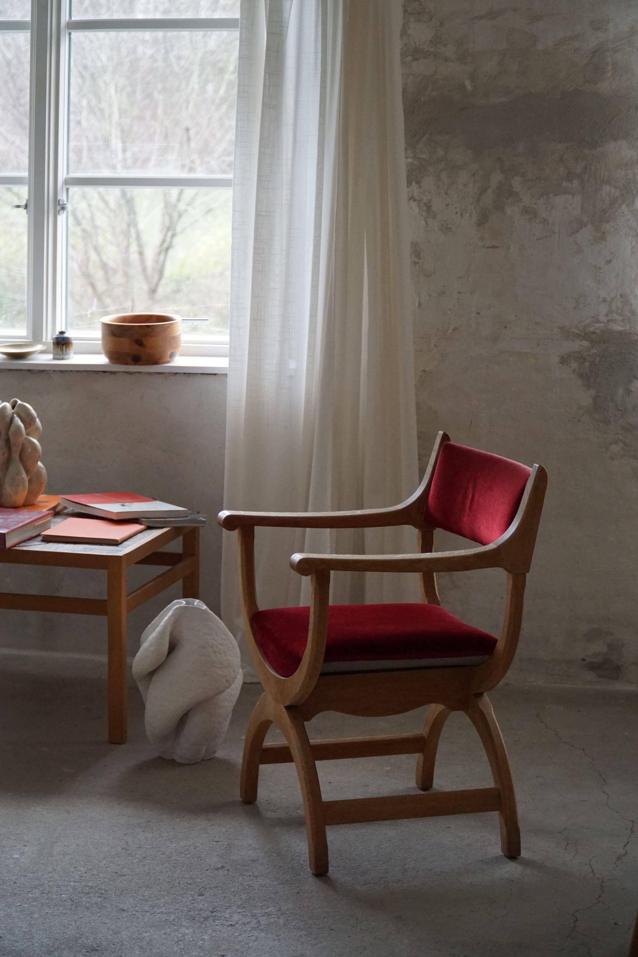 Henning Kjærnulf, armchair in oak and velvet, model "Kurul", mid-century, 1960s.