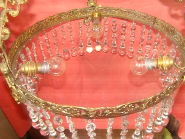 circular chandelier with a brass frame equipped with crystal drops
