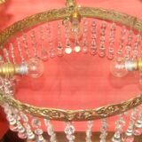 circular chandelier with a brass frame equipped with crystal drops
