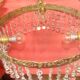 circular chandelier with a brass frame equipped with crystal drops