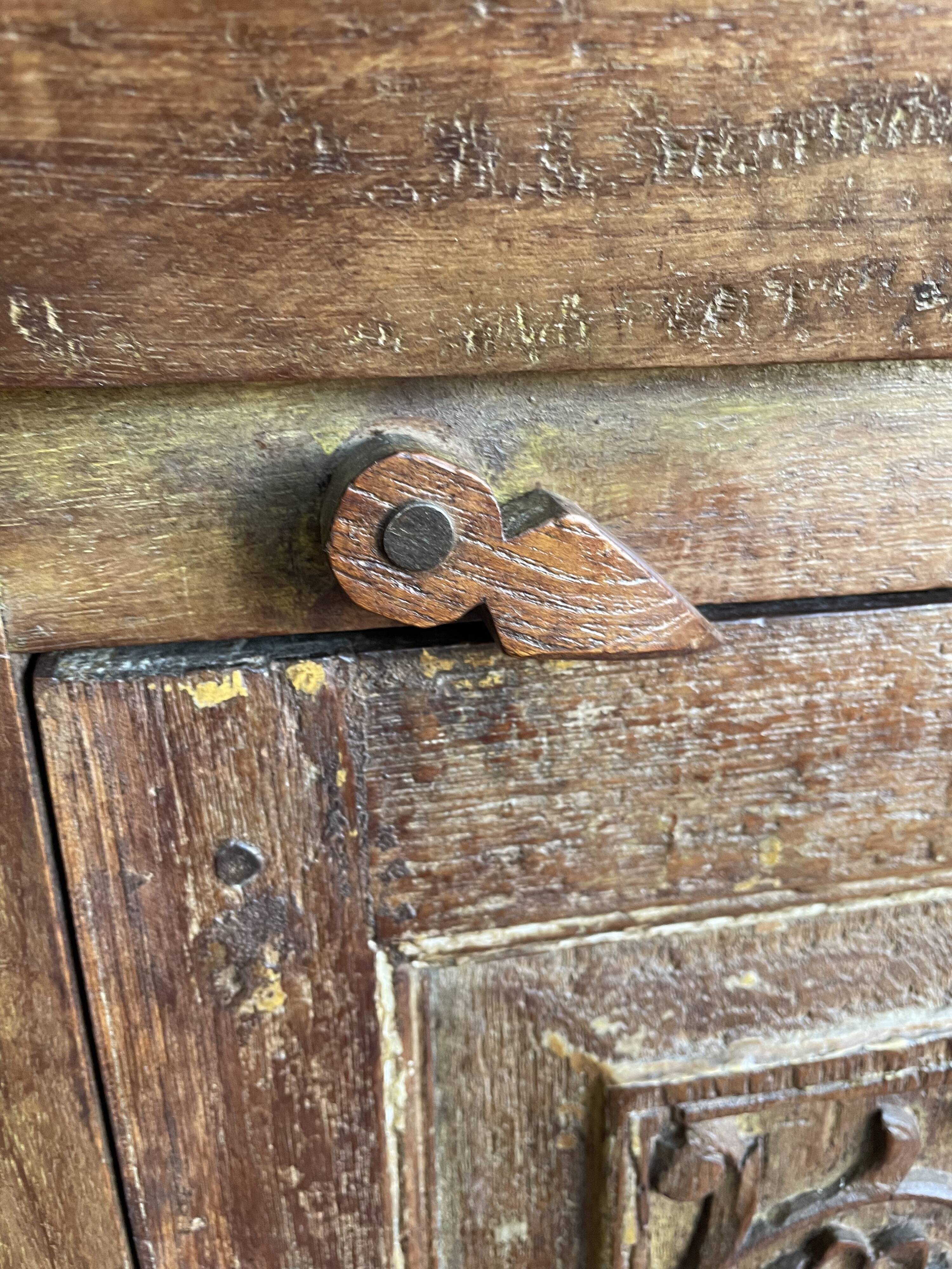 India. Bonnetière with a teak door finely carved by hand.