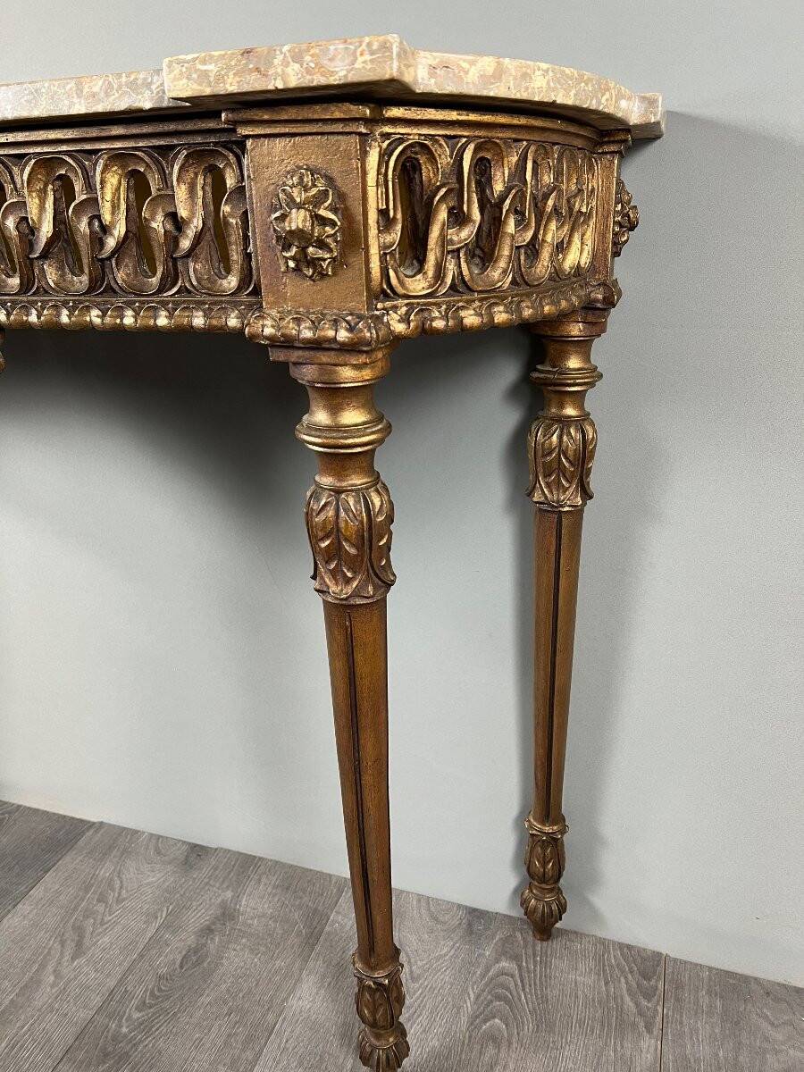 Louis XVI style console in carved wood with a gilded patina, 19th century.