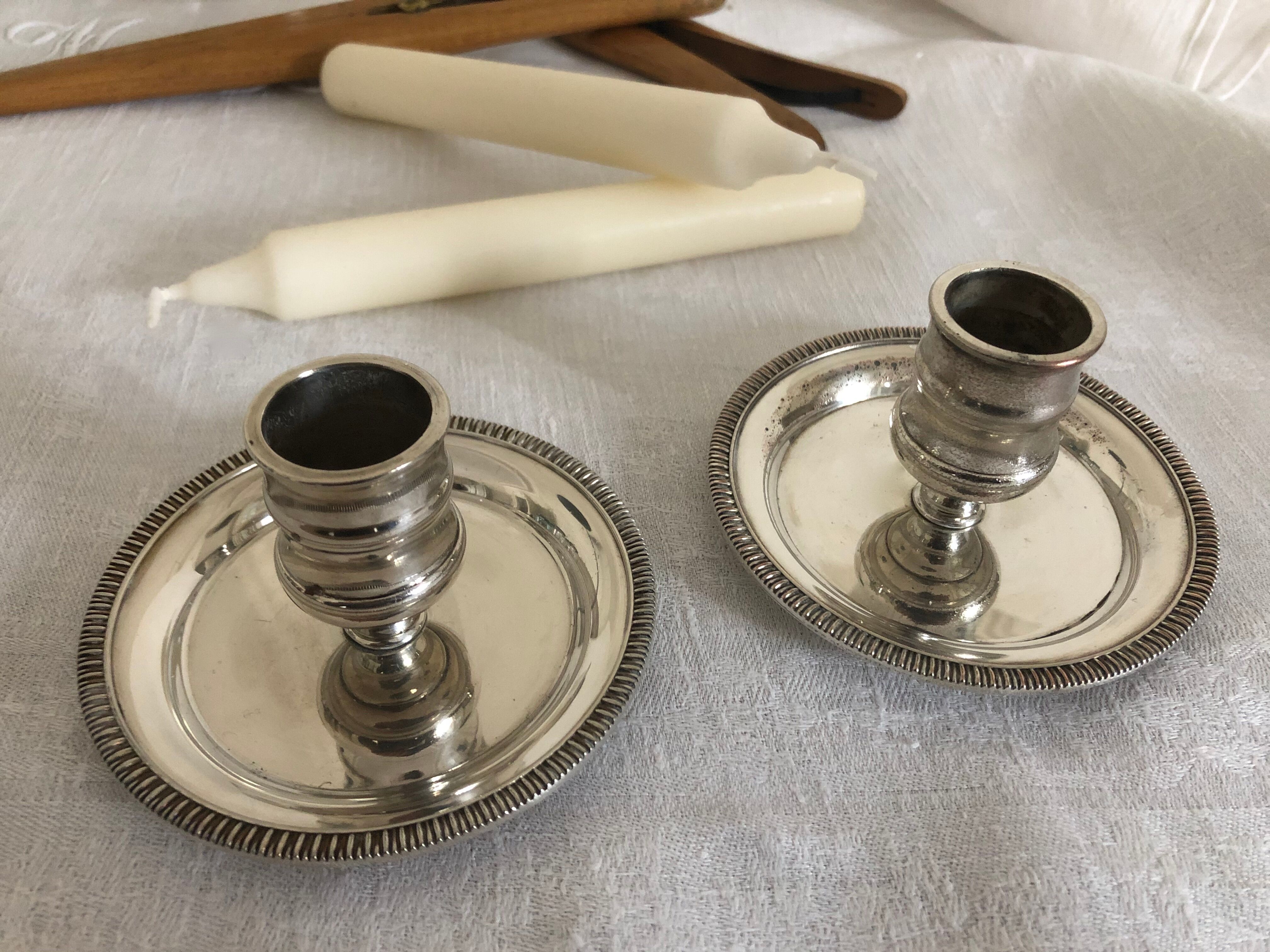Two silver metal candlesticks