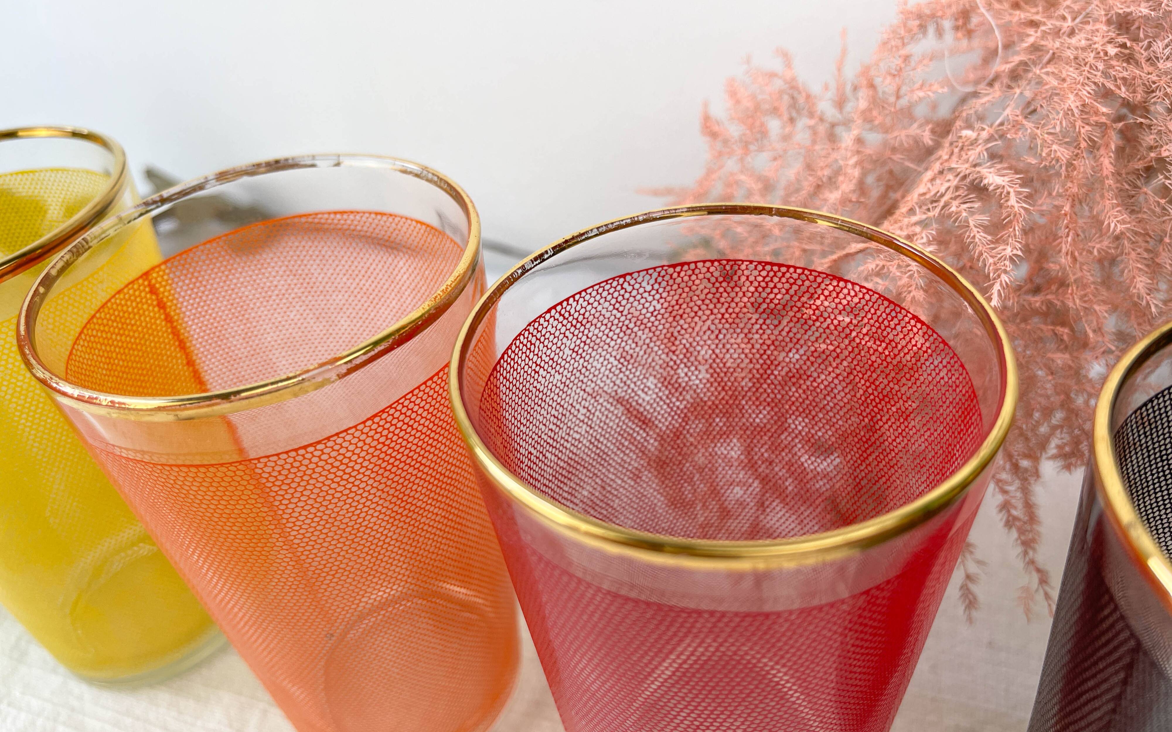 6 colorful juice glasses in their vintage basket
