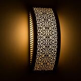 Moroccan brass wall light with intricate floral decoration