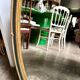 Oval mirror in wood and green and gold stucco, 75 x 42 cm