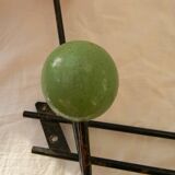Small wrought iron coat rack with wooden balls.