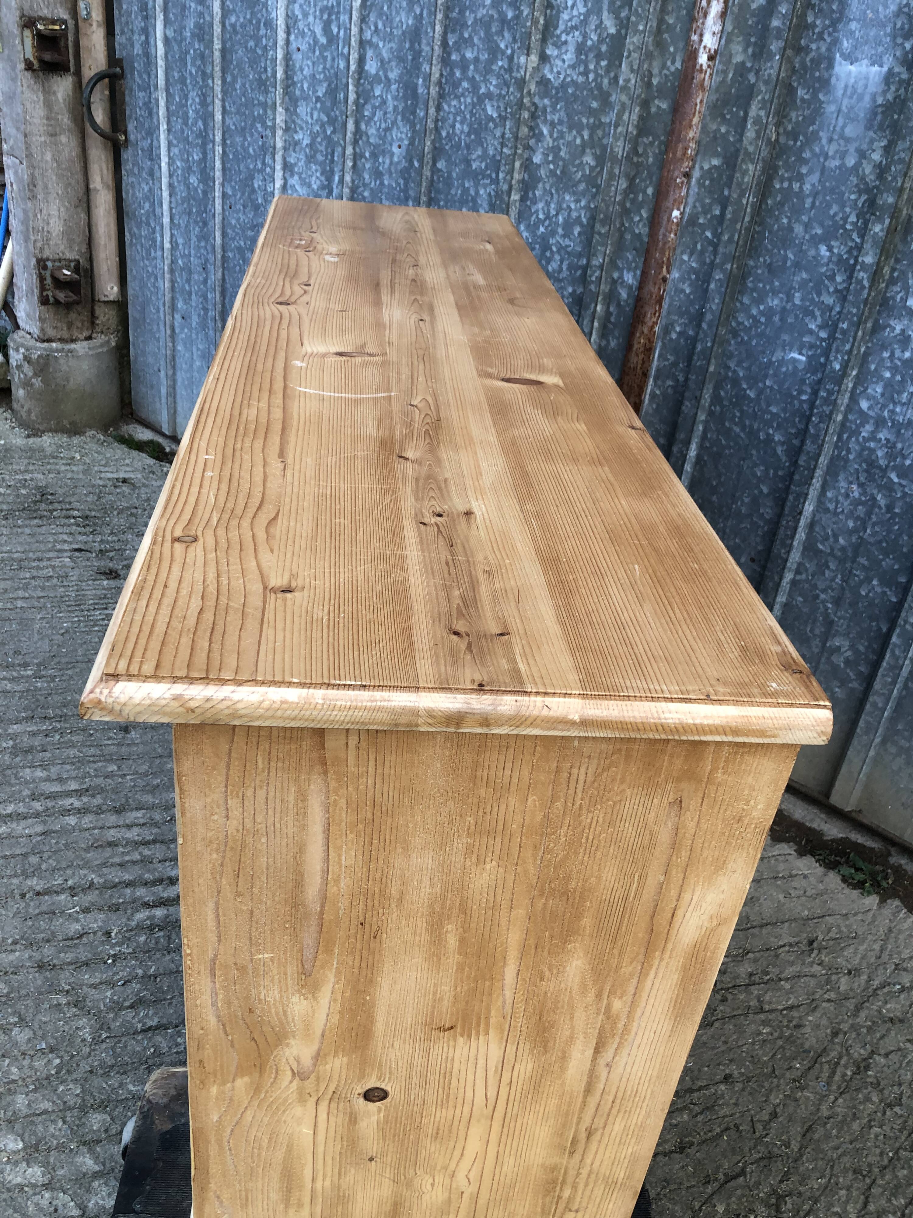 Scandinavian natural pine sideboard with 4 doors and 6 drawers.