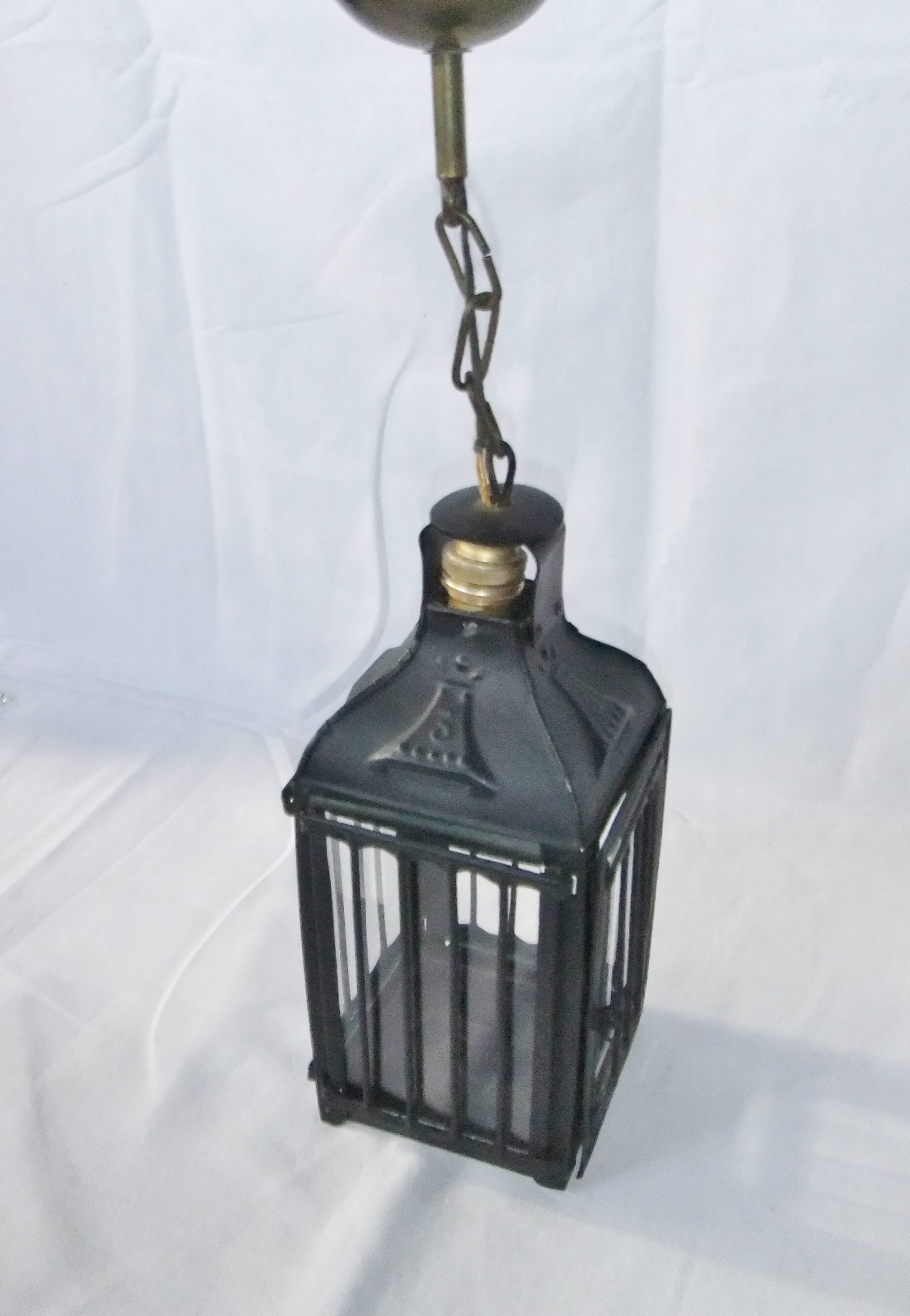 Old chandelier hanging lantern with candle in sheet metal