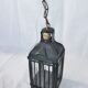 Old chandelier hanging lantern with candle in sheet metal