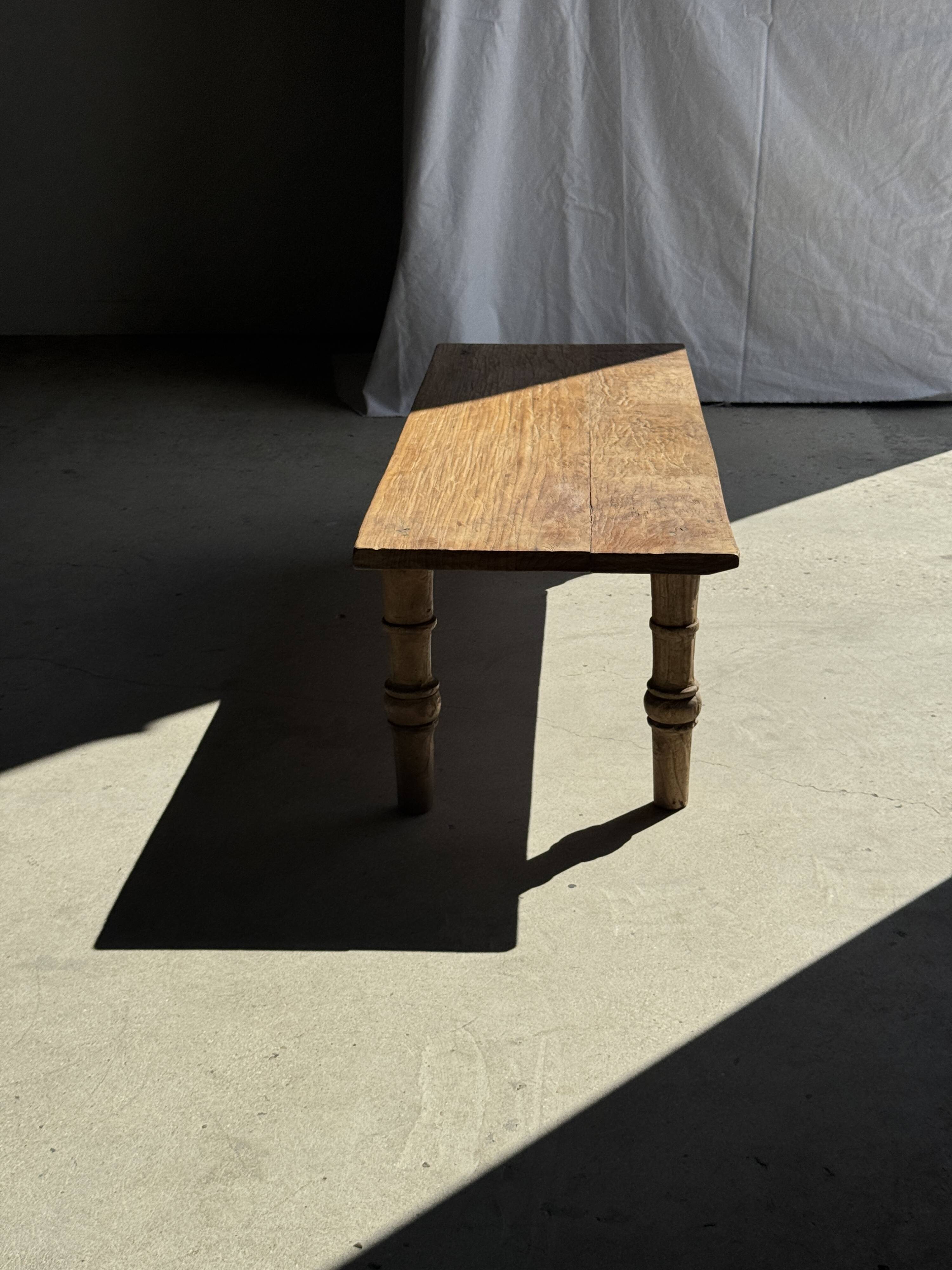 Brown Indonesian teak coffee table, with a border and cylindrical legs H40 L103.
